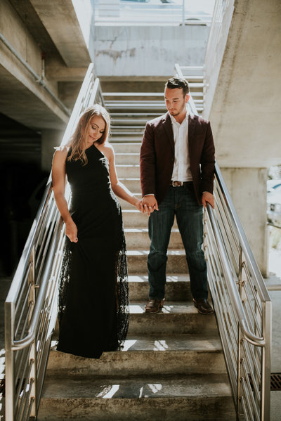 Couple standing on the stairs for their engagement photos at Crystal Bridges Museum of Art in Bentonville, Arkansas