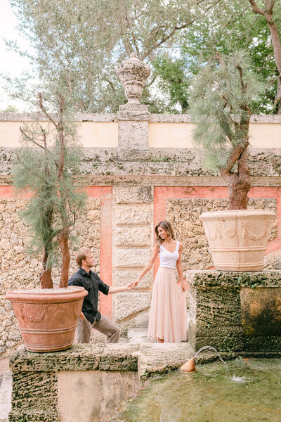 Bride and groom sitting on stairs at Vizcaya Miami