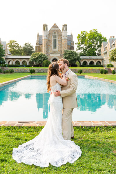 engaged couple holding hands in front of a stone building