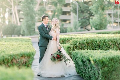 Bride and Groom embrace on the grounds of the Center Club Orange County