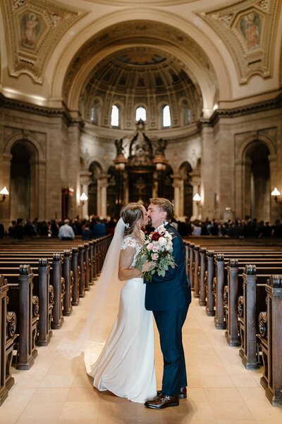 a bride and groom walking through a church