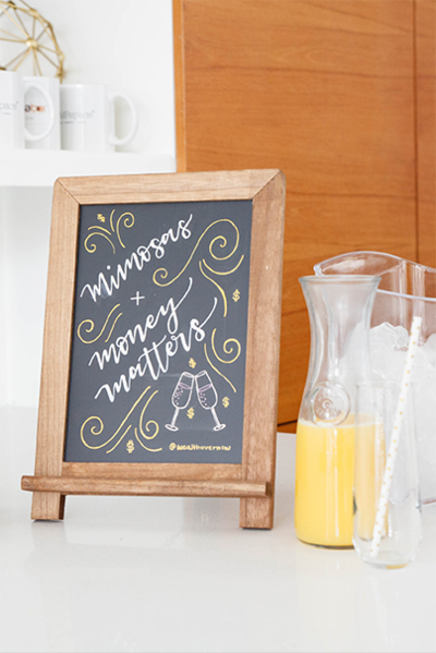 Mini chalkboard with the words Mimosas + Money Matters