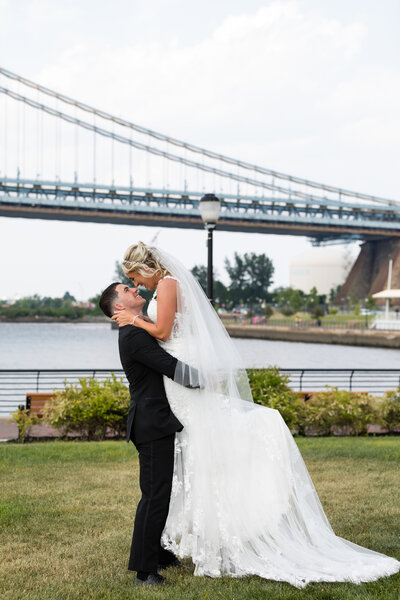 Mallard island bride and groom kissing near water