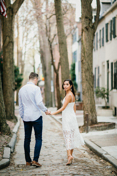 Engaged couple explore the narrow cobble stone streets of Old City for their engagement session.