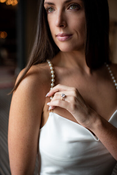 Bride shows off her ring and dress detail at her Hotel Jerome Wedding