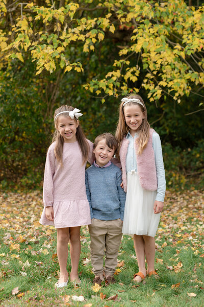 brother and sisters smiling at the camera