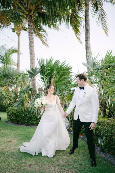 Bride and Groom walking toward the camera on their wedding day in Miami, Florida