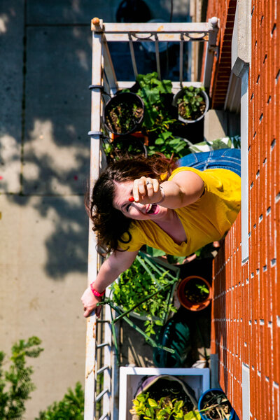 Woman happily gardening on her small balcony