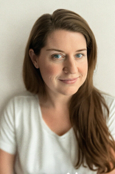 Portrait of photographer Angela Gaul with long light brown hair wearing a white t-shirt Hudson Valley wedding photographer