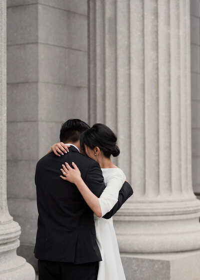 a couple hugs after eloping in the city. A boston micro wedding,.