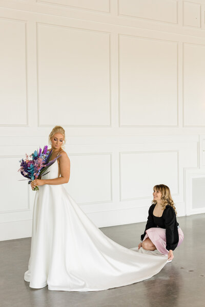 Wedding planner fluffing bridal gown at The Winslet in Wichita, KS - Lively Photography