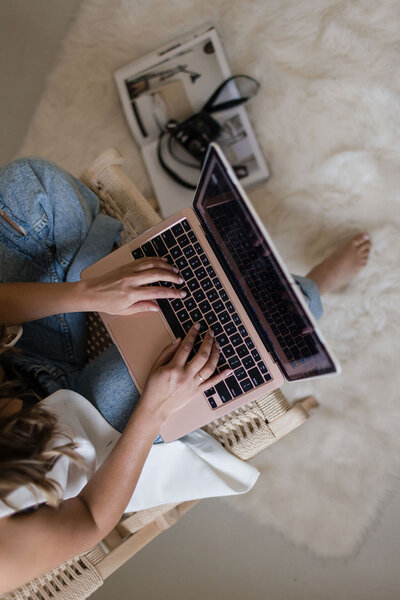 Martina Biljan, copywriter and creative brand strategist  typing on laptop