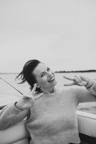 woman smiling at camera on the lake