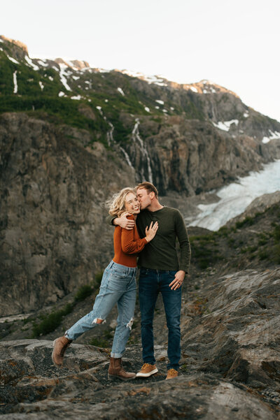 couple embracing beneath glacier