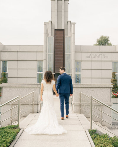 Naomi and John walk towards the Hague Netherlands temple after their sealing ceremony
