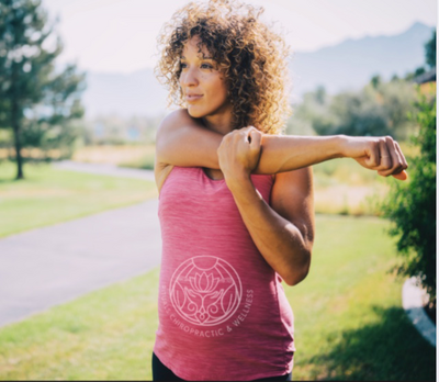 rituals chiropractic branded tank top on woman stretching arm