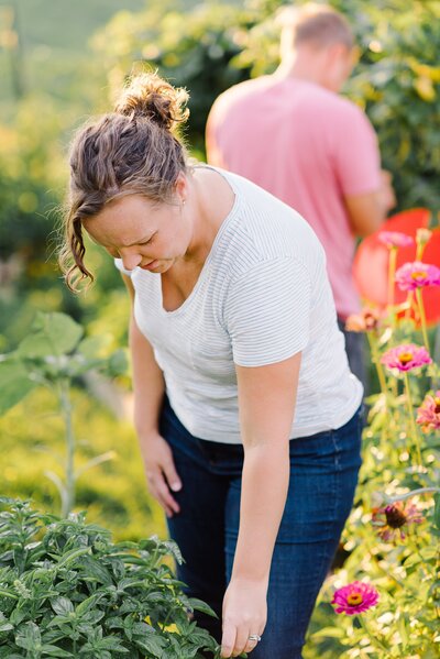 Lexington KY's family photographer, Priscilla Baierlein, in her garden picking basil.