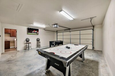 Game room with Cornhole, Air Hockey & Foosball table in this three-bedroom, two-bathroom vacation rental lake house that sleeps eight just steps away from Stillhouse Hollow Lake in Belton, TX.