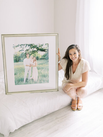 photo of Talia Laird Photography holding large framed print that she custom framed. photographer in madison wi Talia Laird Photography