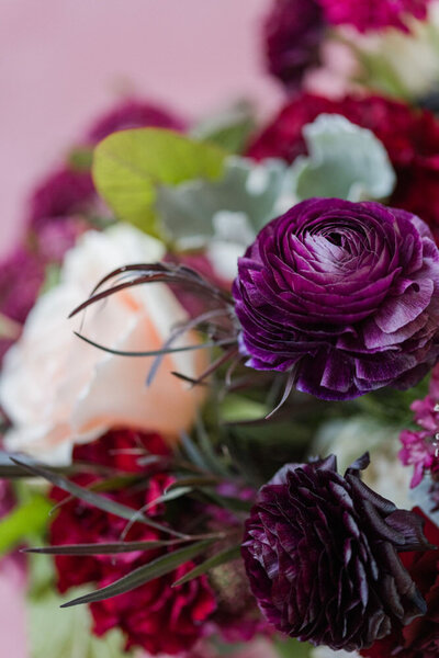 deep red and blackberry flowers in bridal bouquet at fall wedding