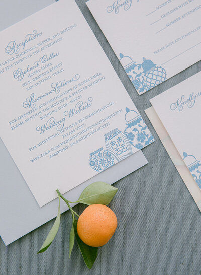 Blue letterpress printed wedding invitation with ginger jar designs