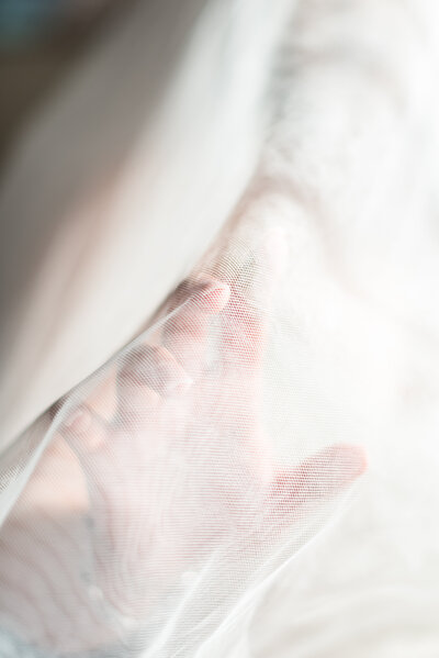 Bride's hand photograph through the veil