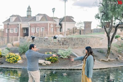 Engaged couple have a Harry Potter wand fight during their Heritage Park Cerritos engagement session