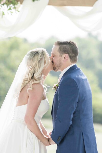 husband and wife having their first married kiss
