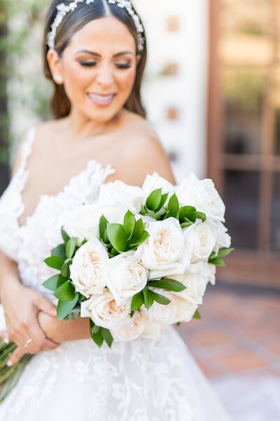 Bride holding long stem rose bouquet at Hummingbird Nest Wedding Venue in Santa Susana, California.
