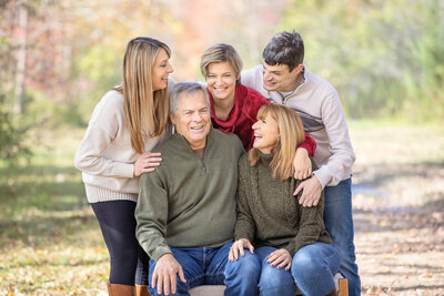 family laughing for timeless photos at a park in Pennington, New Jersey.