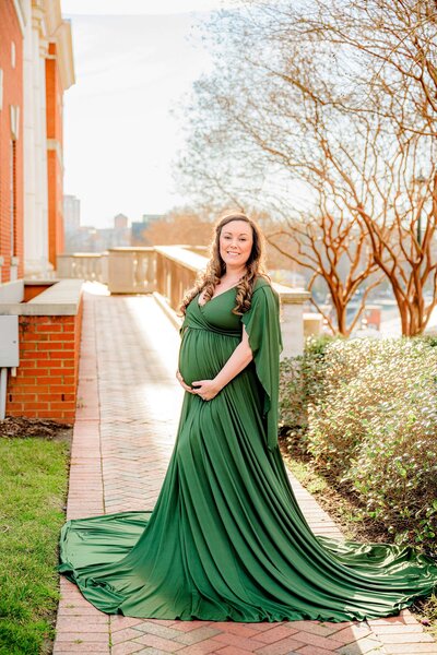 uncc campus charlotte maternity image with mom in green dress and campus behind her