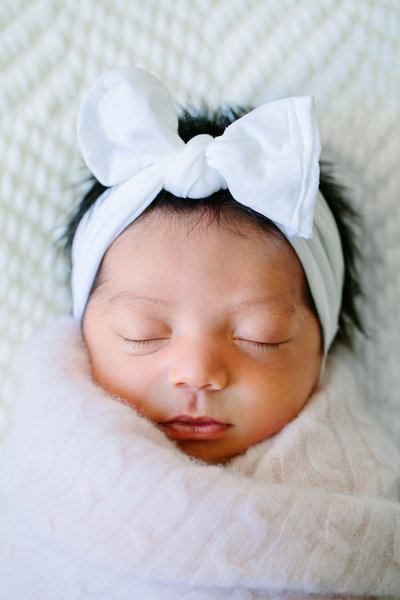 A sleeping newborn bay girl is photographed during her studio newborn session with Camarillo newborn photographer Daniele Rose