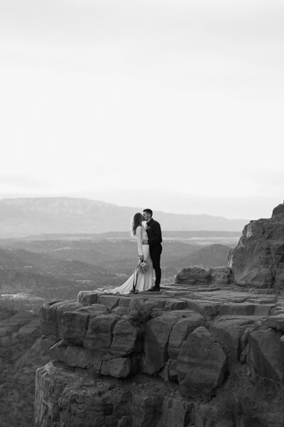 couple standing on cliff edge