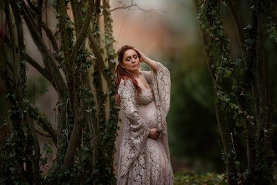 Pregnant woman standing with trees around her photo taken by Southeast Michigan maternity photographer Kat Figlak