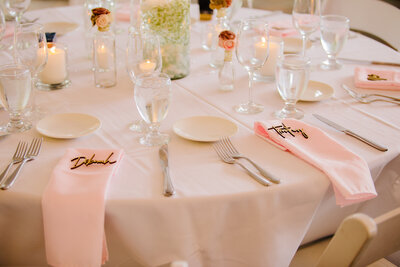 pink wedding table settings and decor with white plates and pink tablecloth