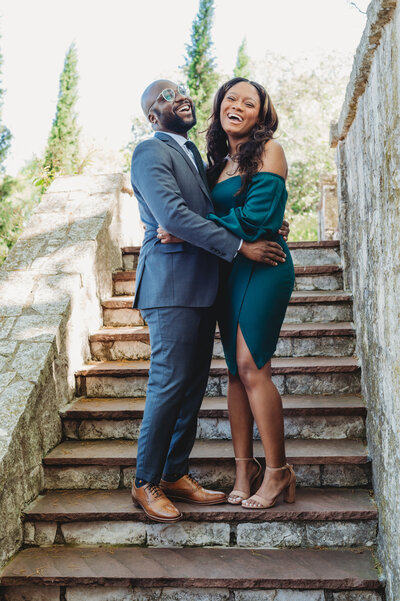 black couple engagement photoshoot at Dallas arboretum botanical garden wearing green dress and navy blue suit portrait photo taken by blessing daniel photography