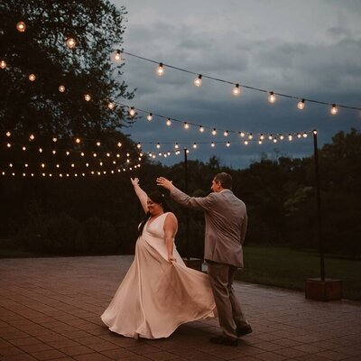 Plus-size Edith Elan bride dancing with the groom after their Morton Arboretum wedding in Chicago Illinois.