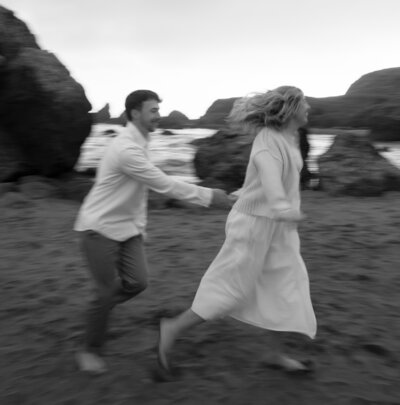 couple running secret beach oregon engagement photos