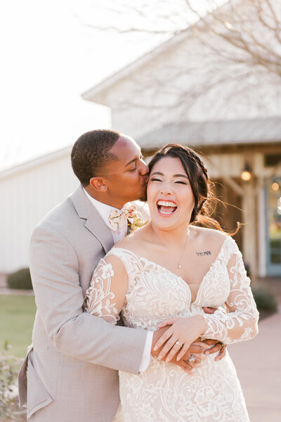 Bride and groom holding  hands  during portraits at the Silo and Oaks wedding venue in Temple Texas photographed by  Belton Wedding Photographer Carmen J Williams Photography.