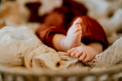 Close up picture of baby's feet in moses basket