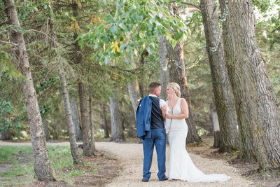 photo of wedding couple in a forest walking path