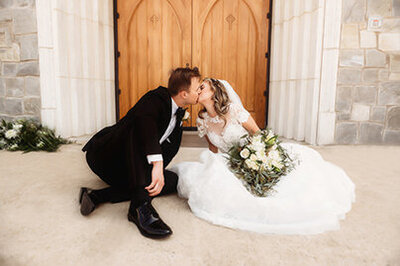 Couple kisses in front of Church doors during theirElopement in Asheville, NC.