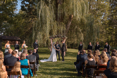 an outdoor wedding ceremony at barnwood events, a wedding venue in madison, winconsin.