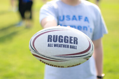 USAFA Women's player holding rugby ball - Zoomie Rugby