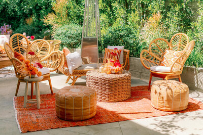 tropical style outdoor seating, including rattan chairs and leather floor poufs