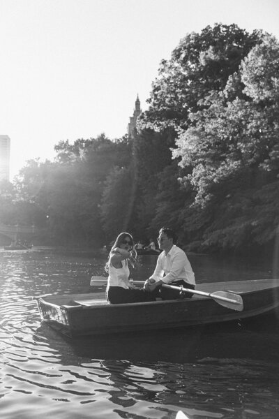 Couple posing for photo in a boat in central park