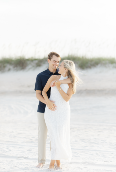 engaged couple posing on the beach during engagement portraits at kathryn abby hanna park in atlantic beach florida
