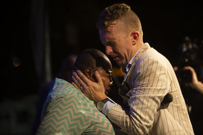 Evangelist Jonathan Shuttlesworth prays for a woman with cancer at Festival of Life in Newark NJ