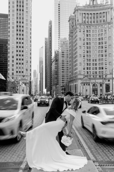 man and woman kissing on chicago street wedding day