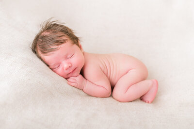 baby with wrinkled back laying for his portrait captured by Niagara newborn photographer Kristine Marie Photography